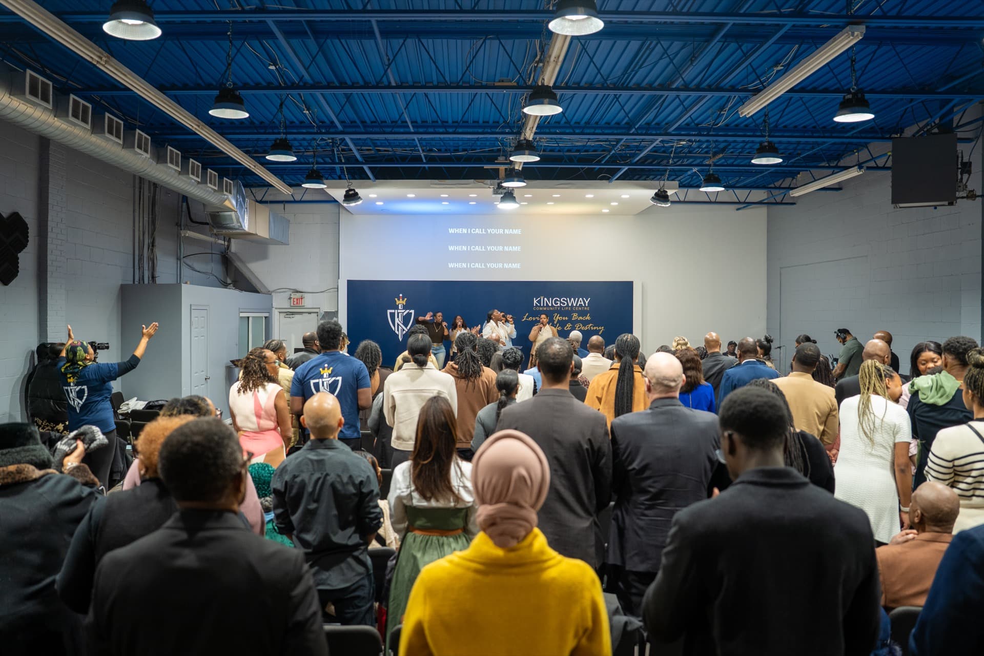 KCLC congregation standing in worship